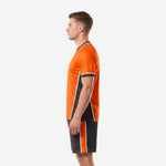 Right side view of orange and black soccer kit with vertical stripe shorts and honeycomb jersey pattern