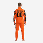 Close-up of orange soccer tracksuit jacket with jet black sublimated splash panels and full-length center zip