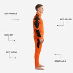 Orange soccer tracksuit pants detail showing black outer-thigh graphic panel and tapered leg cut
