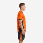 Side view of orange sublimated soccer outfit showing charcoal side panels and white trim detailing