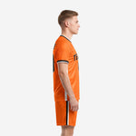 Side view of orange sublimated kits soccer uniform showing black and white leg stripe