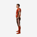 Reverse side view of orange and brown custom team football uniform showing sleeve number placement and pant stripe detail