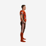 Side view of orange and brown sublimated american football uniform showing brown side panels sleeve stripe and brown pants with white double side stripe