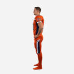 Right-side view of orange football uniforms with navy side panel detail on jersey and navy-white pant stripe running down the outer thigh