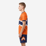 Right side view of men's orange and navy custom soccer uniform set with chevron detail on shorts leg