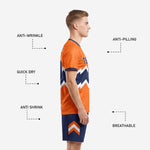 Close detail of navy soccer shorts with orange and white chevron sublimation print on left leg panel