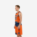 Side view of orange basketball uniform showing navy splash pattern transitioning from jersey hem into matching shorts waistband
