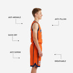 Back view of orange youth basketball uniform showing player name and number sublimated in white and navy on orange jersey