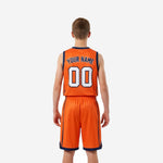 Opposite side view of custom orange youth basketball uniform set showing matching jersey and shorts with navy trim