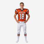 Orange and navy youth football camp uniforms full set front view showing V-neck jersey with navy shoulder panels and white pants with side stripe
