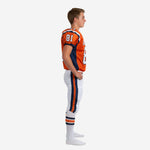 Side view of orange navy youth american football team uniforms showing navy side panel on jersey and double stripe on white football pants