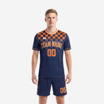 Men's orange soccer uniform with navy blue checkerboard yoke and matching shorts, front view, K2 Sportswear custom kit