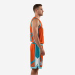 Left side view of orange teal female basketball uniform style kit showing shorts geometric panel detail