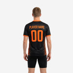 Close-up of orange contrast trim on V-neck collar of black custom soccer training jersey