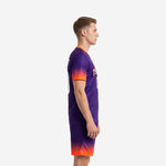 Left side view of custom soccer uniform kits for teams showing Royal Purple to Neon Orange gradient on jersey and matching shorts