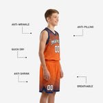 Back view of orange and navy youth basketball jersey showing back player name and number placement on halftone sublimated fabric