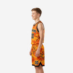 Side view of boys basketball uniforms in orange and black camo showing armhole binding and shorts waistband detail