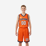 Orange youth basketball uniforms front and back view showing orange and navy V-neck jersey with matching shorts and sublimated team name and numbers