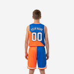 Opposite side view of custom orange and royal blue youth basketball jersey and shorts set showing blue panel and armhole binding detail