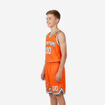 Opposite side view of custom boys basketball uniforms in orange with gray and white splatter print and V-neck binding detail on jersey armhole