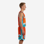 Custom orange youth basketball uniforms with teal wave graphic, full set front and back view showing jersey and shorts