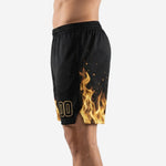 Side view of order custom basketball shorts showing gold flame pattern on left leg panel with ember sparks and ribbed elastic waistband