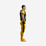 Green and gold American football uniform side view showing raglan gold shoulder panel, set-in sleeve with sleeve number, and gold pants with green leg stripe