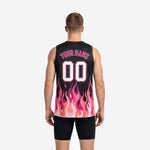 Right side view of pink and black flame sublimated basketball jersey showing sleeveless V-neck cut and full side flame pattern on male model