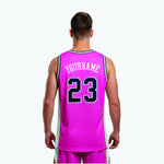 Opposite side view of custom pink basketball jersey design with white panel and navy gold stripe detail visible along the armhole and side seam