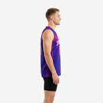 Side view of custom pink basketball jersey showing purple base, magenta armhole binding, halftone dot side panel, and straight hem with side vent at hip
