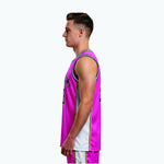 Side view of pink and navy custom basketball jersey showing white side panel, multi-stripe trim in navy and gold along the seam, and sleeveless cut on adult male model