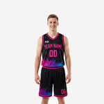 Pink basketball uniforms two-piece set with black base and neon paint-splash graphic showing front team name and number plus matching shorts