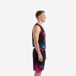Side view of sublimated pink basketball uniform set showing armhole binding, V-neck trim, and paint-splash hem detail on jersey and shorts