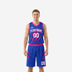 Pink basketball uniforms in royal blue and hot pink with claw-mark sublimated print, front and back view of full jersey and shorts set