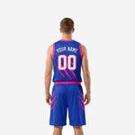 Other side view of blue and pink basketball uniform set displaying matching claw-mark design running from jersey to shorts