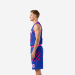 Side view of royal blue and hot pink sublimated basketball uniform showing claw-mark graphic on jersey side panel and shorts leg