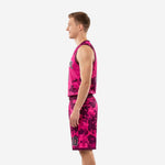 Side view of pink and purple digital camo basketball uniform showing V-neck binding, armhole edge, and shorts hem on male model
