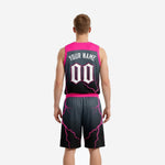 Left side view of custom pink basketball uniform set showing armhole binding and shorts side panel lightning print