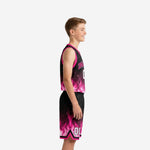 Front view of custom pink and black flame youth basketball uniform with arched team name and number on jersey