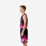 Side view of youth pink flame basketball jersey and matching shorts showing armhole binding and hem stripe detail