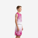 Front view of custom pink and white youth basketball uniform with arched team name, number 00, and V-neck jersey on youth boy model