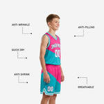 Back view of pink youth basketball uniform set showing full teal and pink diagonal pattern, back number placement, and elastic waistband with drawcord on shorts
