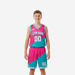 Custom pink youth basketball uniforms with teal diagonal split, arched team name and number 00 on jersey and matching shorts, front and back view
