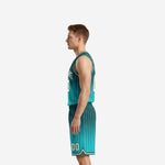 Side view of teal basketball uniform set showing cream pinstripe detail running full length of jersey and shorts with elastic waistband and drawcord