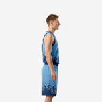 Custom carolina blue basketball uniform front view, V-neck jersey with arced team name and matching shorts with navy waistband