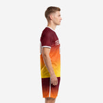 Custom professional soccer team uniform side view showing maroon-to-orange gradient jersey and matching gradient shorts with white outer seam stripe