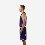 Side view of purple and black galaxy basketball uniform set showing armhole binding, jersey hem, and shorts side panel with silver-grey hem trim