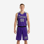Purple and black basketball uniforms two-piece set with curved silver side panels and V-neck jersey worn by adult male model, front view