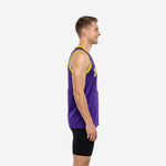 Front view of custom purple and gold basketball jersey with yellow arced team name, white and gold front number, and yellow armhole binding on male model