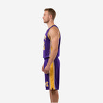 Opposite side view of custom purple and gold basketball uniform showing gold side panel and shorts leg panel alignment on adult male model